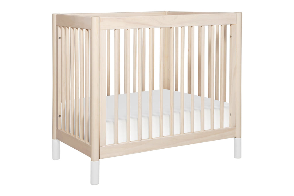 M12998NXW, Gelato 2-in-1 Mini Crib in Washed Natural with White Feet at angle